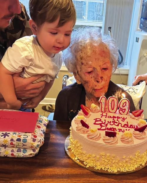 Mary Lee Mewis’ great, great grandson Hudson helps her blow out her candles on her birthday cake last Wednesday at her 109th birthday party in La Grange. Photo courtesy of Stacie Karstedt