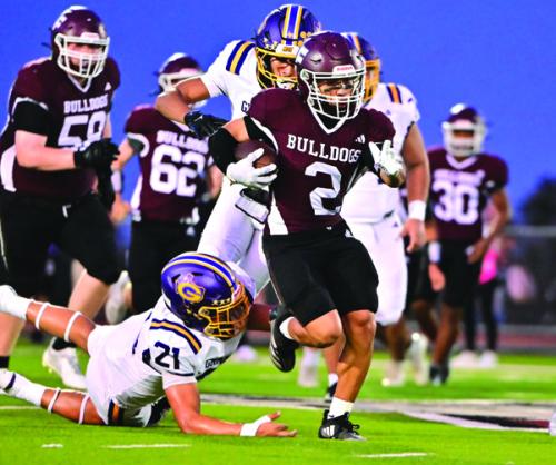 Zayden Perez breaks a tackle and picks up a first down for the Flatonia Bulldogs Friday. Photos by Stephanie Steinhauser