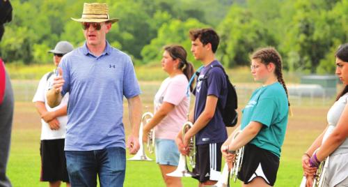 Director Chris Cooper speaks to the band, giving them directions for the next drill. Photo by MaKenzie Givan